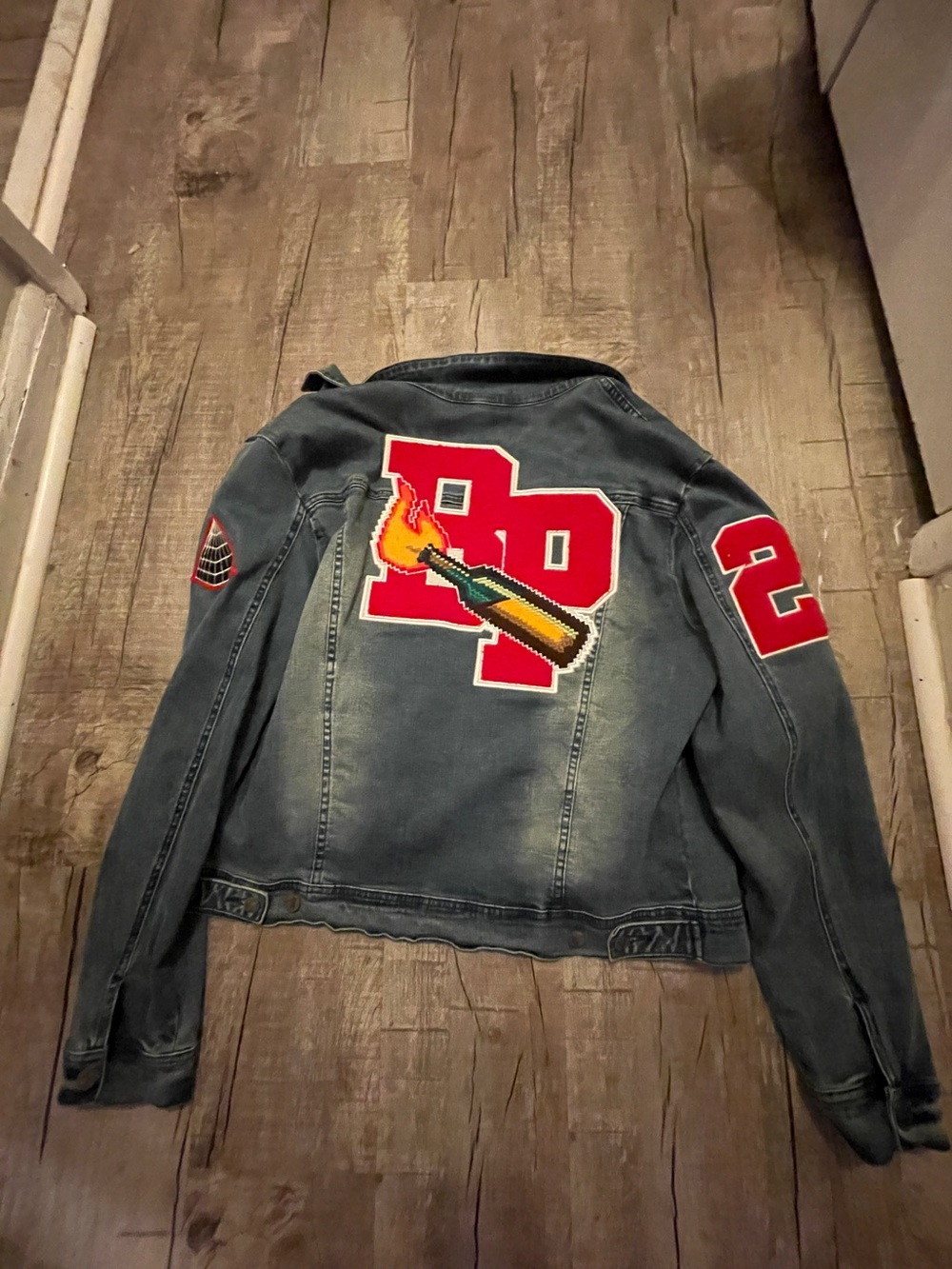 Black Pyramid Denim Jacket with Bold Red Patch Graphics